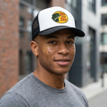Man wearing a cap with a logo in an urban setting